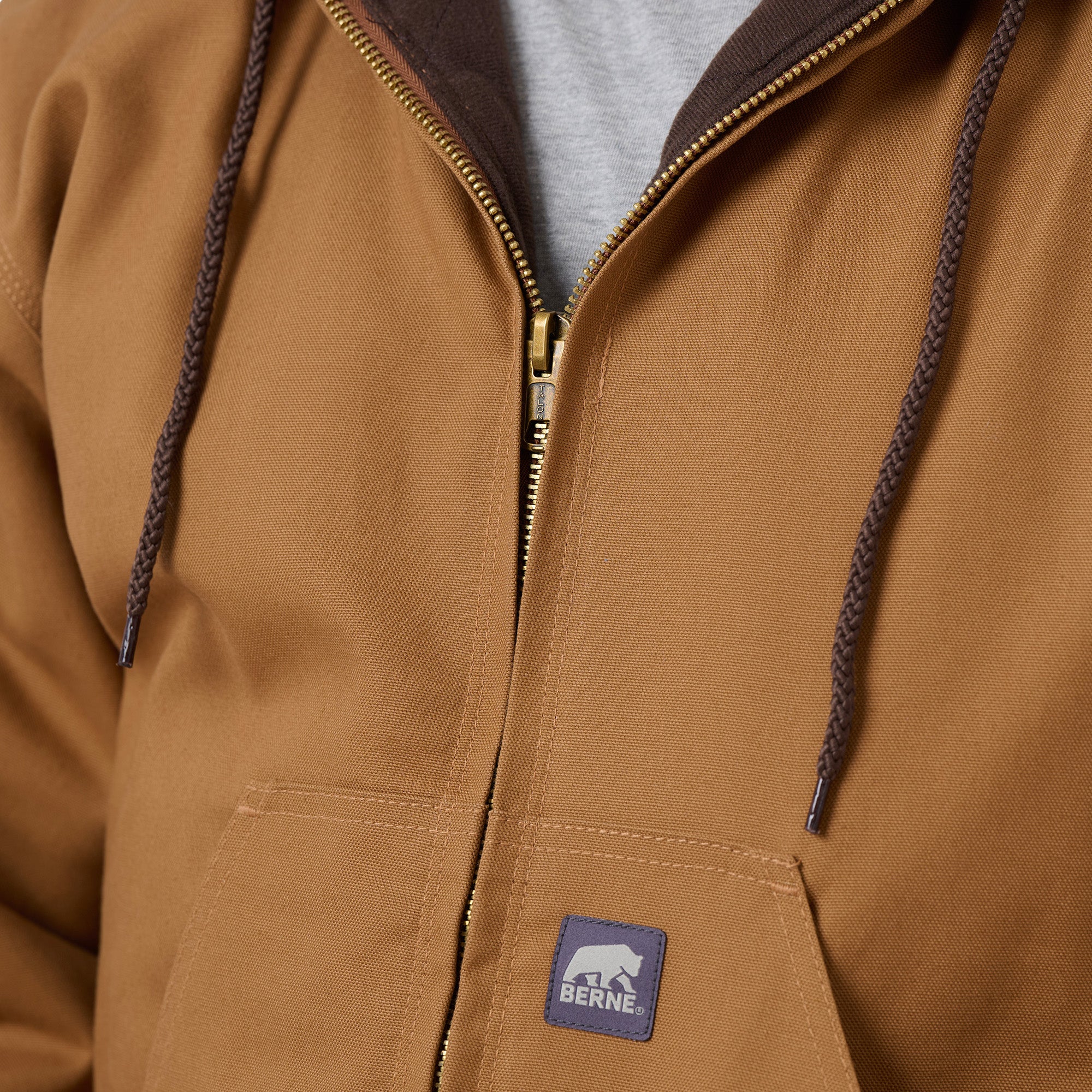 Close detail of brown hooded duck work jacket