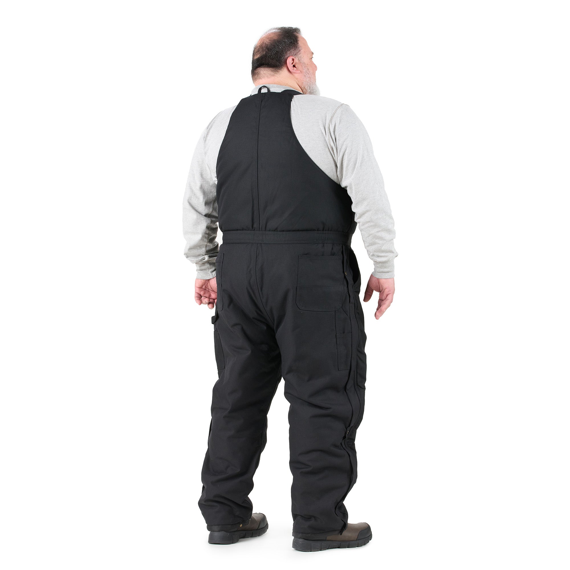 Back view of black insulated bib overalls, alternate shot