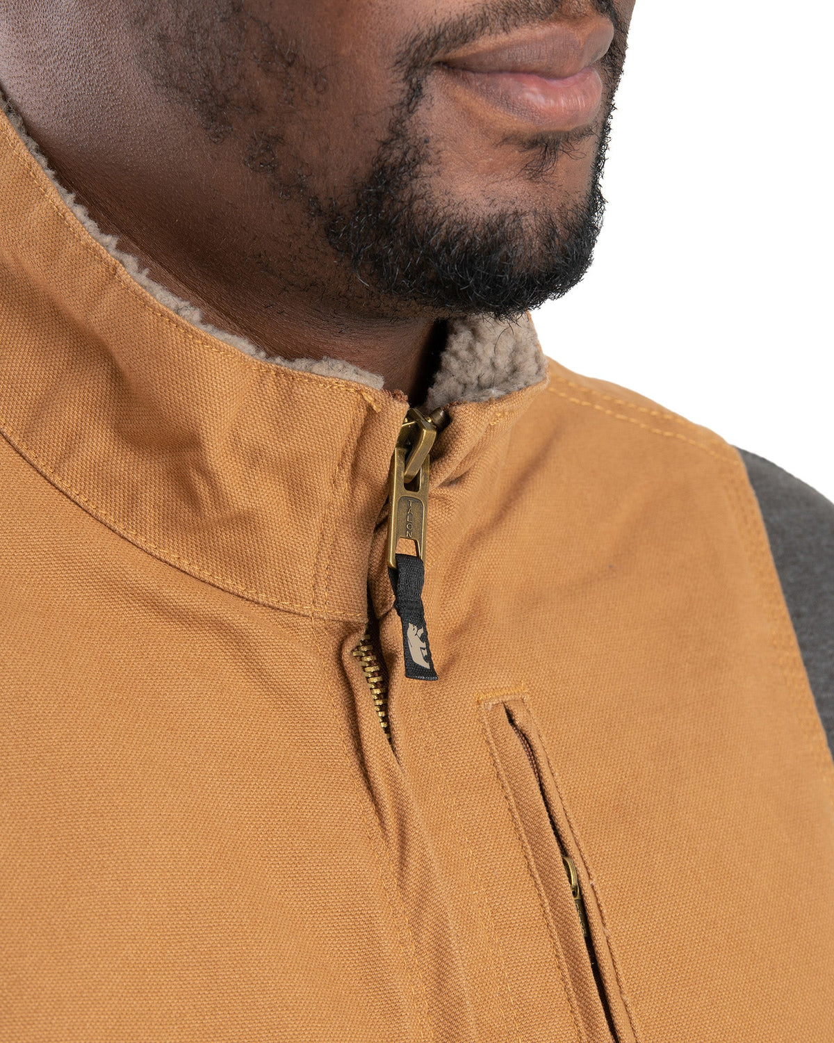 Close detail of sherpa lined washed duck vest, alternate shot