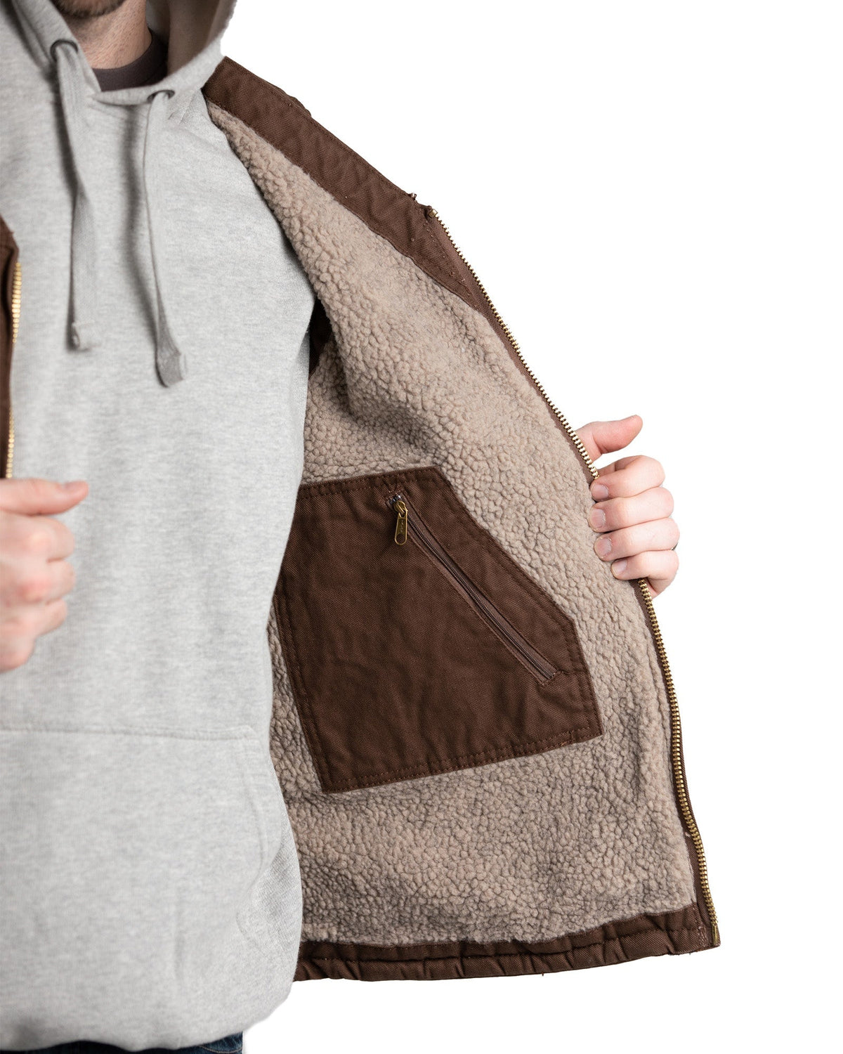 Close detail of v neck sherpa lined duck vest, alternate shot